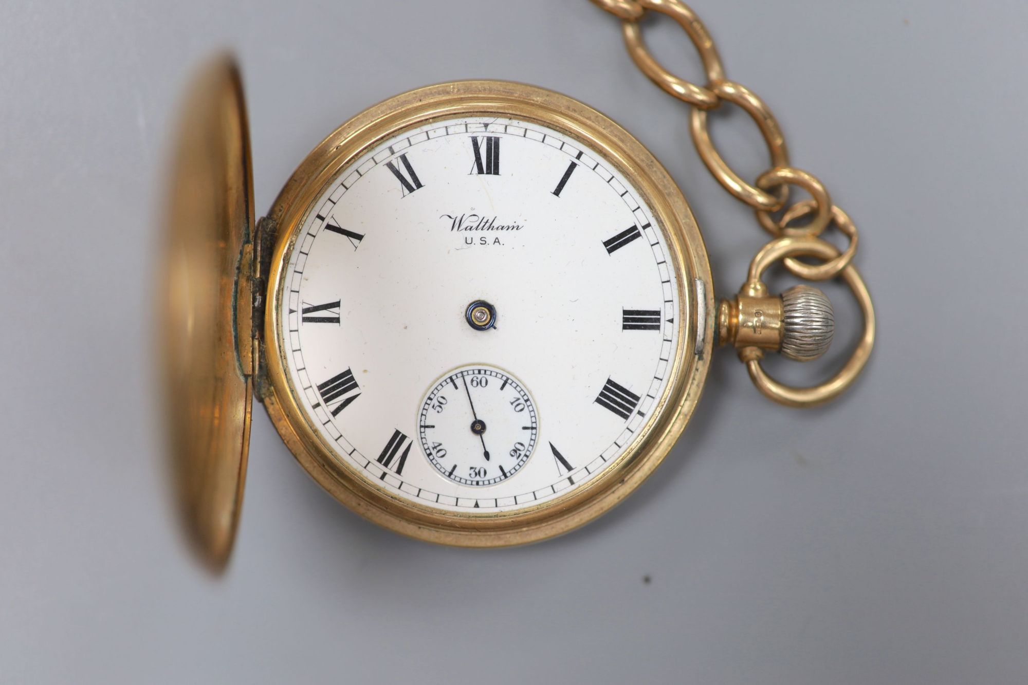 A George V 9ct gold Waltham half hunter pocket watch, with a 9ct gold albert.